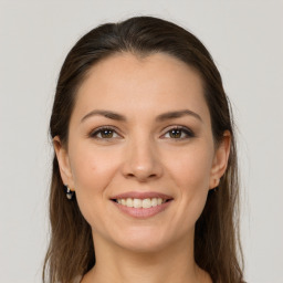 Joyful white young-adult female with long  brown hair and grey eyes