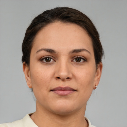 Joyful white young-adult female with short  brown hair and brown eyes