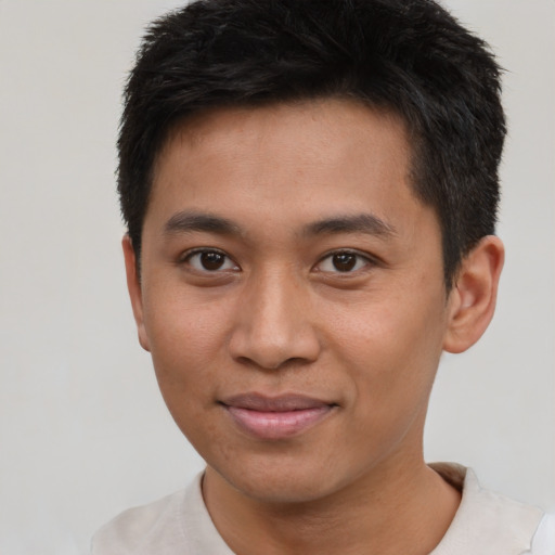 Joyful asian young-adult male with short  brown hair and brown eyes