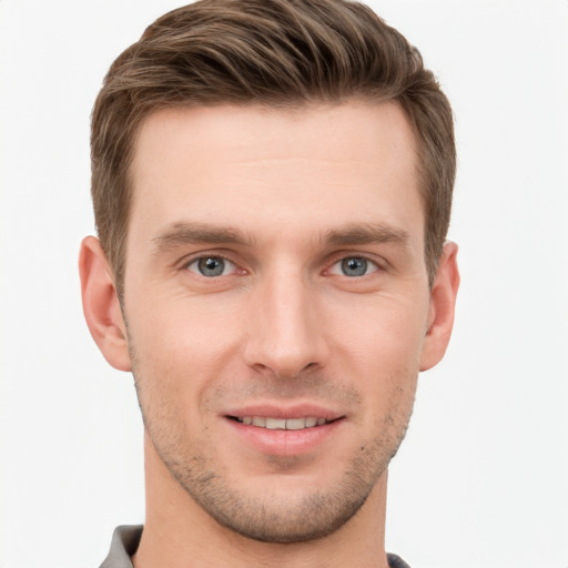 Joyful white young-adult male with short  brown hair and grey eyes