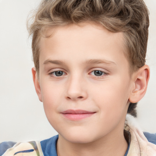 Joyful white child male with short  brown hair and blue eyes