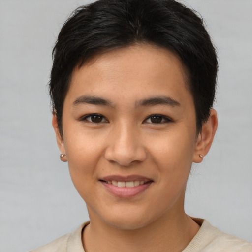 Joyful asian young-adult female with short  brown hair and brown eyes