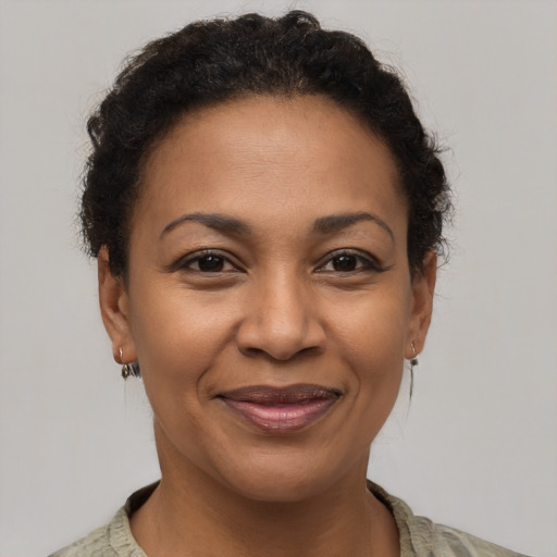 Joyful latino adult female with short  brown hair and brown eyes