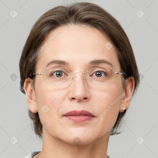 Joyful white adult female with medium  brown hair and grey eyes