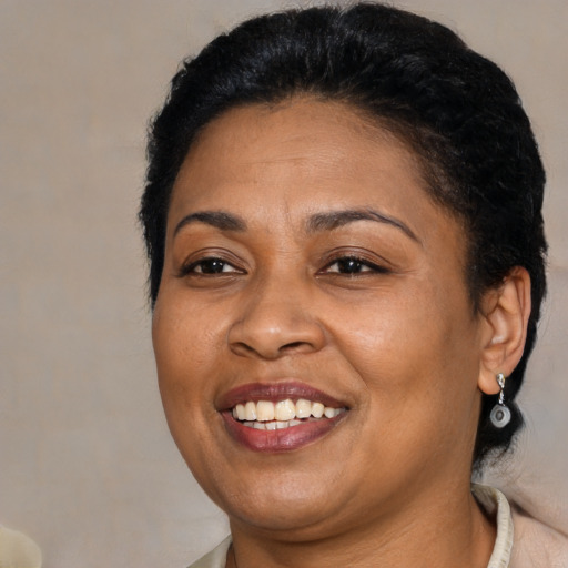 Joyful latino adult female with short  brown hair and brown eyes