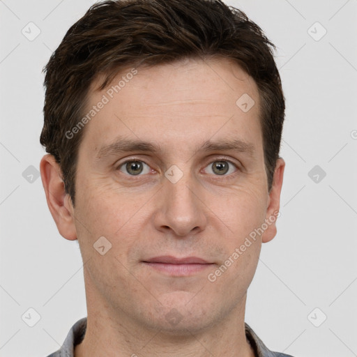 Joyful white adult male with short  brown hair and grey eyes