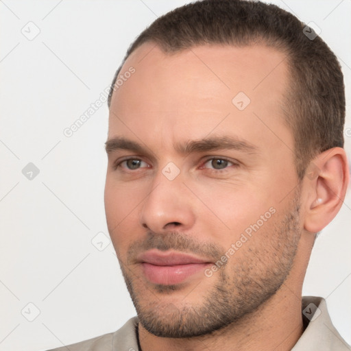 Joyful white young-adult male with short  brown hair and brown eyes