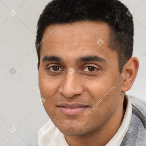 Joyful white young-adult male with short  black hair and brown eyes