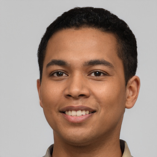 Joyful latino young-adult male with short  black hair and brown eyes
