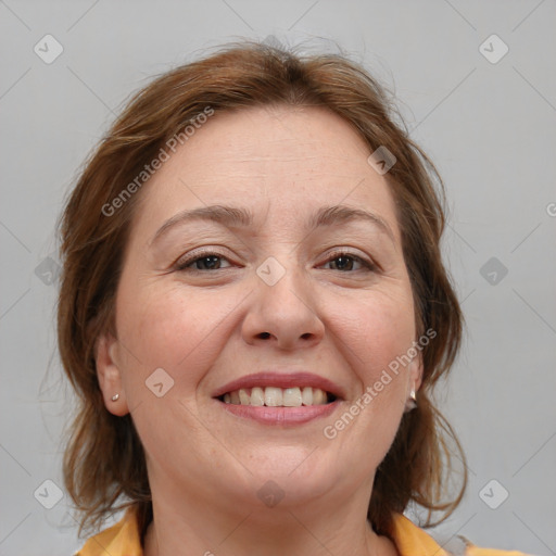 Joyful white adult female with medium  brown hair and brown eyes