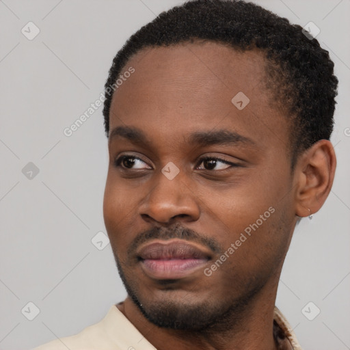Joyful black young-adult male with short  black hair and brown eyes