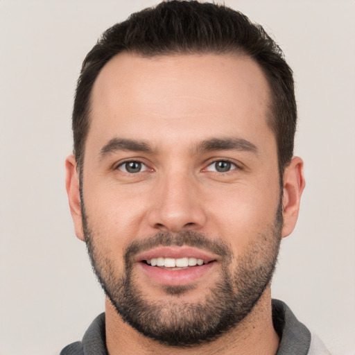 Joyful white young-adult male with short  brown hair and brown eyes