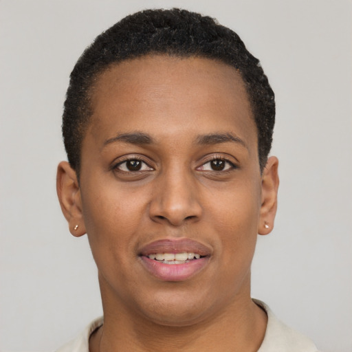 Joyful black young-adult female with short  black hair and brown eyes