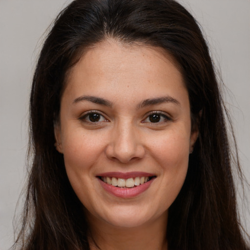 Joyful white young-adult female with long  brown hair and brown eyes