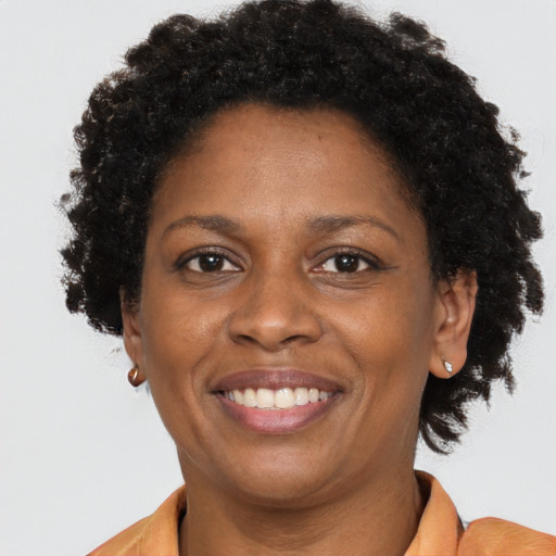Joyful black adult female with short  brown hair and brown eyes