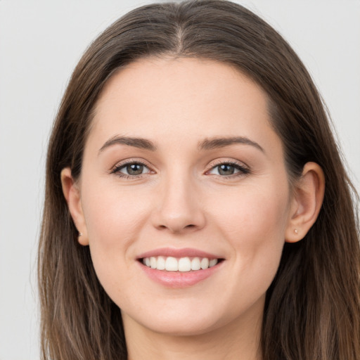 Joyful white young-adult female with long  brown hair and grey eyes