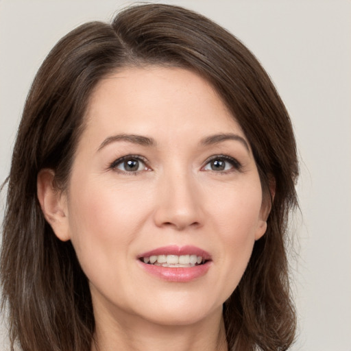 Joyful white young-adult female with medium  brown hair and brown eyes