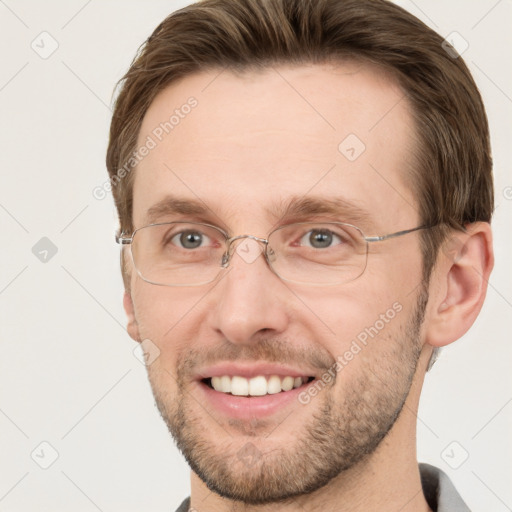 Joyful white adult male with short  brown hair and grey eyes