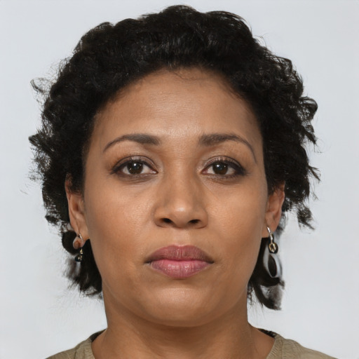 Joyful latino adult female with short  brown hair and brown eyes