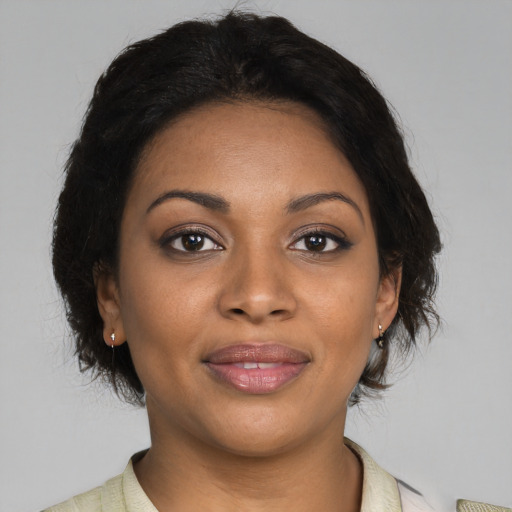 Joyful black young-adult female with medium  brown hair and brown eyes