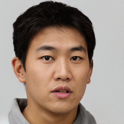 Neutral asian young-adult male with short  black hair and brown eyes