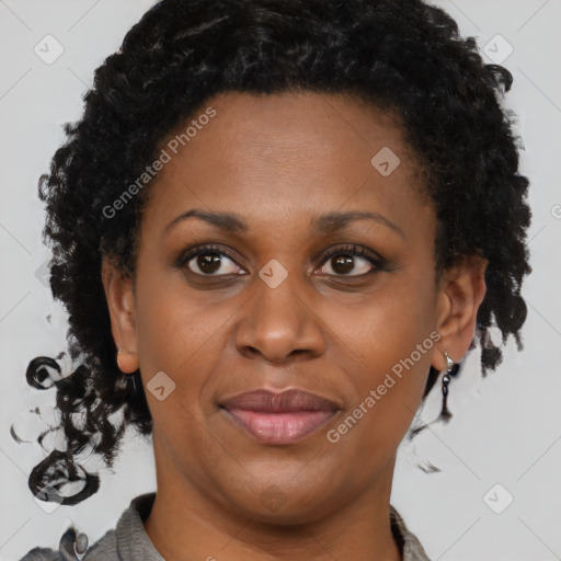 Joyful black adult female with short  brown hair and brown eyes