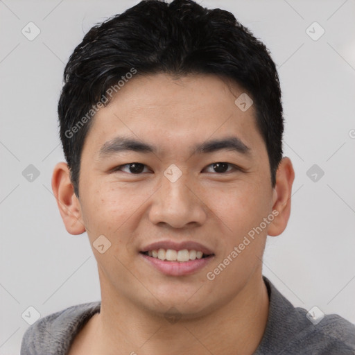 Joyful asian young-adult male with short  brown hair and brown eyes