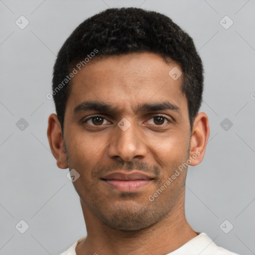 Joyful black young-adult male with short  black hair and brown eyes