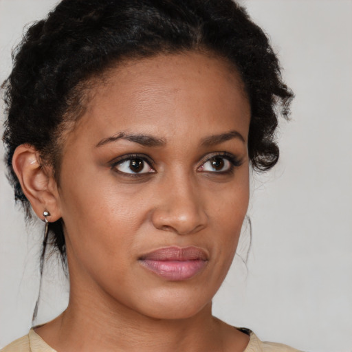 Joyful black young-adult female with medium  brown hair and brown eyes