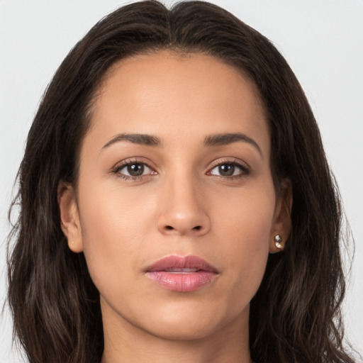 Joyful white young-adult female with long  brown hair and brown eyes