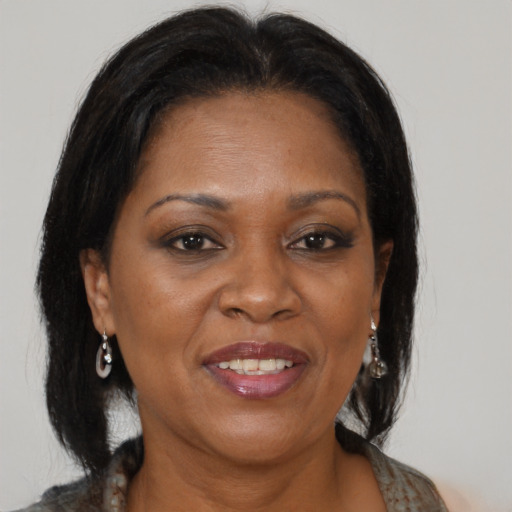Joyful black adult female with medium  brown hair and brown eyes