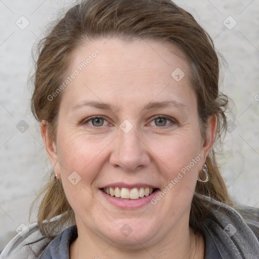 Joyful white adult female with medium  brown hair and grey eyes