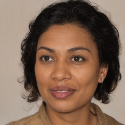 Joyful black adult female with medium  brown hair and brown eyes