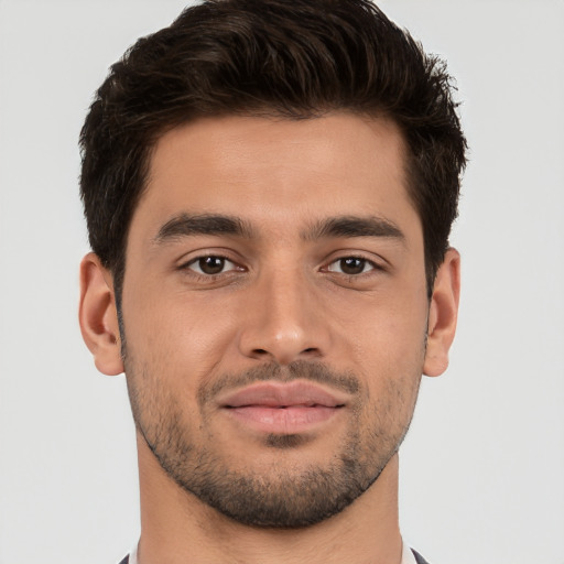 Joyful white young-adult male with short  brown hair and brown eyes