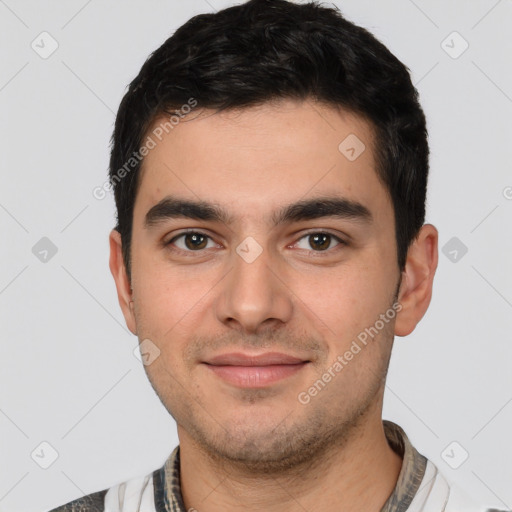 Joyful white young-adult male with short  black hair and brown eyes