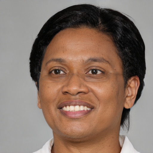 Joyful black adult female with short  black hair and brown eyes