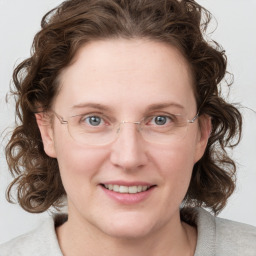 Joyful white young-adult female with medium  brown hair and blue eyes