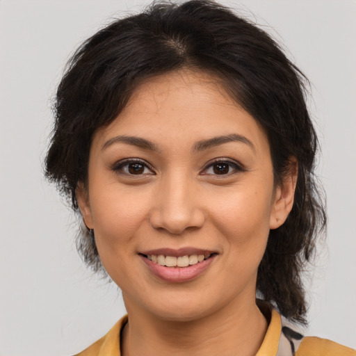Joyful asian young-adult female with medium  brown hair and brown eyes