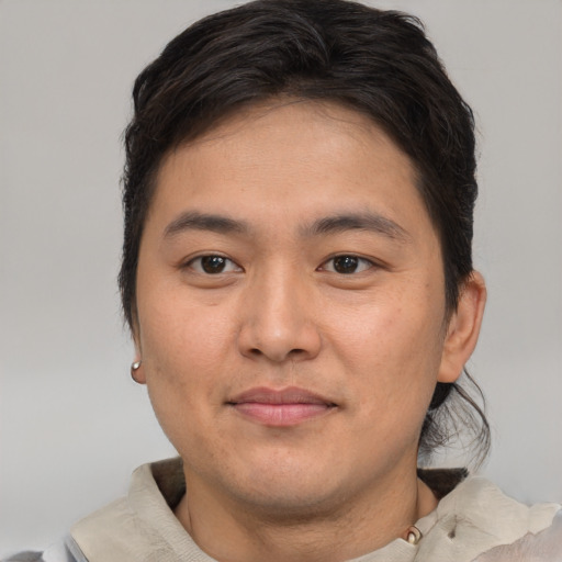 Joyful asian young-adult male with short  brown hair and brown eyes