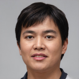 Joyful asian young-adult male with short  black hair and brown eyes