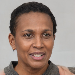 Joyful black adult female with short  brown hair and brown eyes