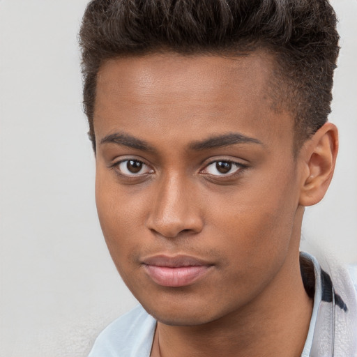 Joyful black young-adult male with short  brown hair and brown eyes