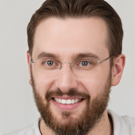 Joyful white adult male with short  brown hair and grey eyes