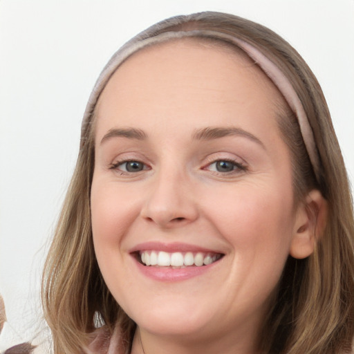 Joyful white young-adult female with long  brown hair and blue eyes