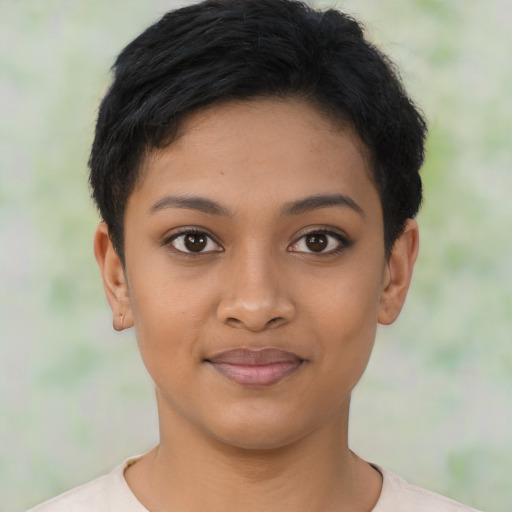 Joyful latino young-adult female with short  black hair and brown eyes