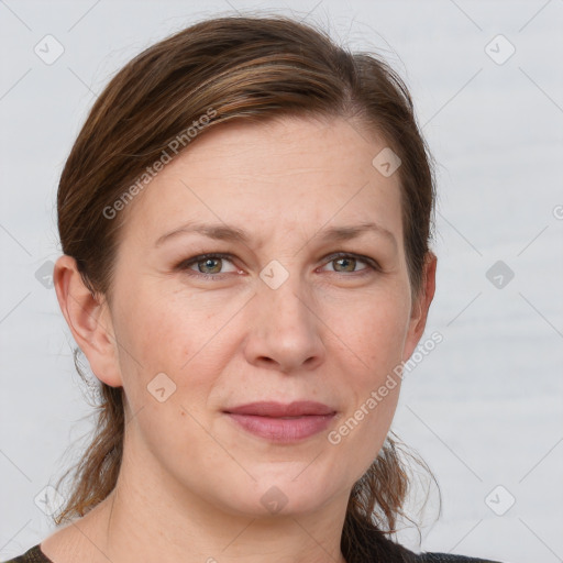 Joyful white adult female with medium  brown hair and grey eyes