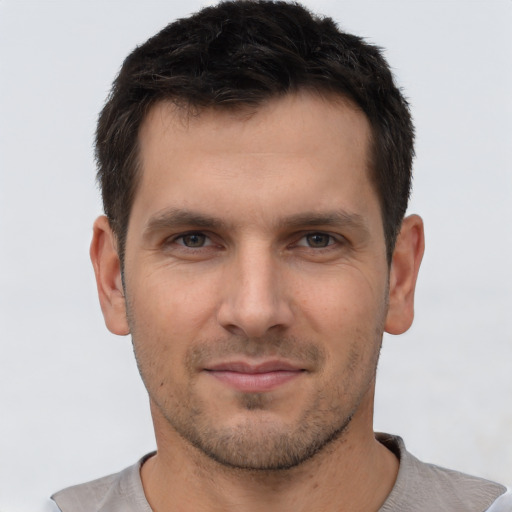 Joyful white young-adult male with short  brown hair and brown eyes