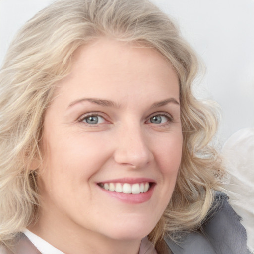 Joyful white young-adult female with medium  blond hair and blue eyes