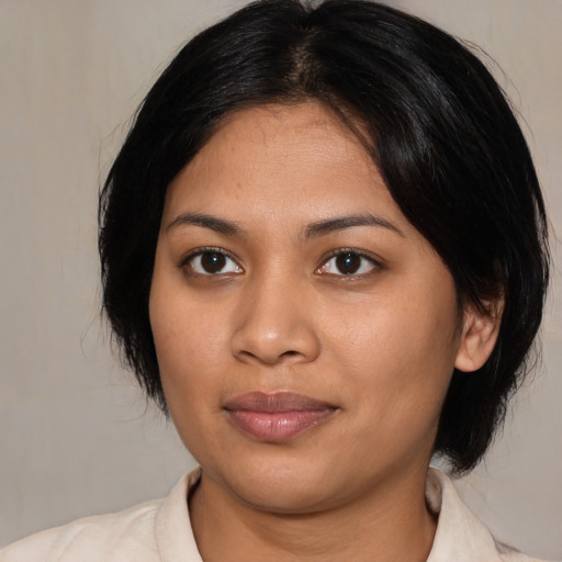 Joyful latino young-adult female with medium  black hair and brown eyes