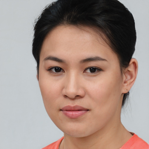 Joyful asian young-adult female with short  brown hair and brown eyes